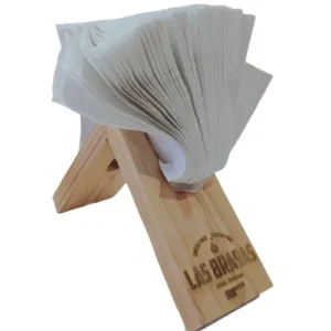 Servilletero triangular de madera de pino con servilletas de papel, grabado con el logo del restaurante Las Brasas.